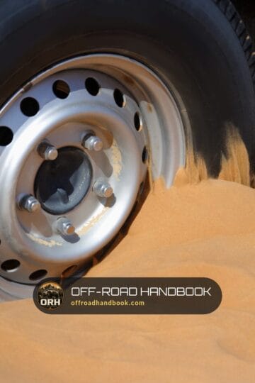 Steel wheel of a 4x4 spinning and digging into soft sand — Off-Road Handbook