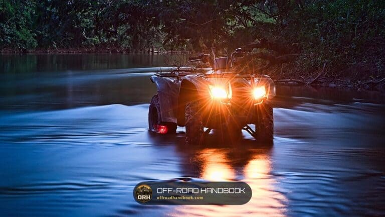 ATV with headlights on crossing a river at dusk — Off-Road Handbook