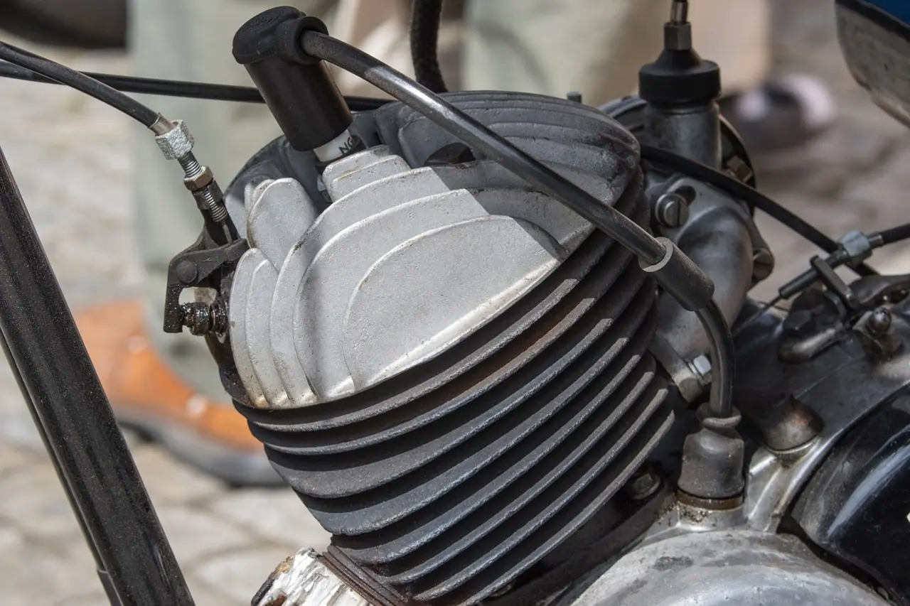 Air-cooled single-cylinder motorcycle engine with the spark plug cap and ignition lead running to the cylinder head (generic engine, not a Bayou 300)