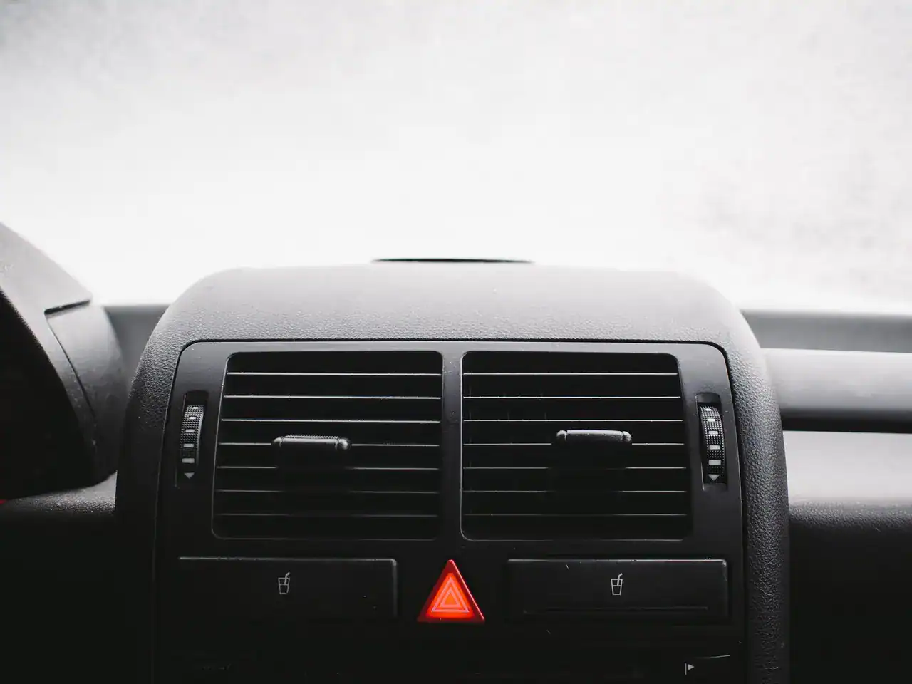 Fogged windshield above the dashboard air vents and heating panel of a car (not a Jeep)