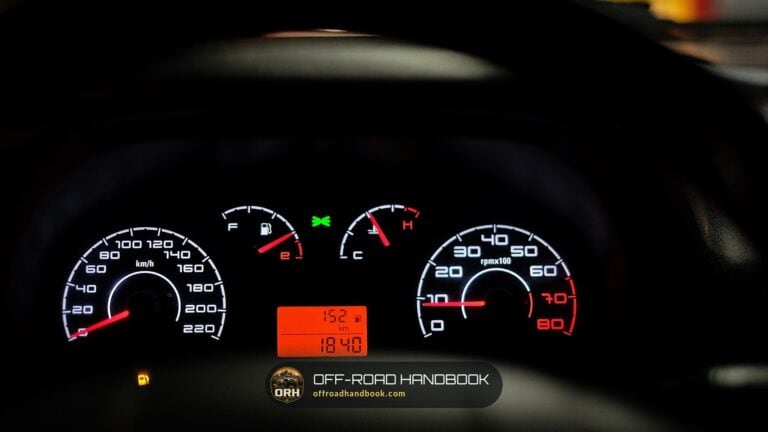 Car instrument cluster lit up at night — Off-Road Handbook