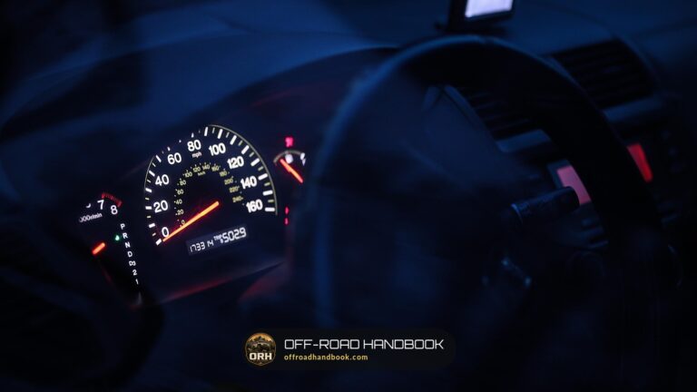 Instrument cluster glowing at night with warning lights on the gauges — Off-Road Handbook