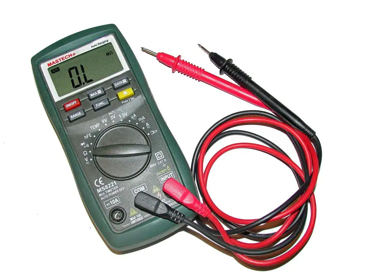 Digital multimeter with red and black test leads on a white background