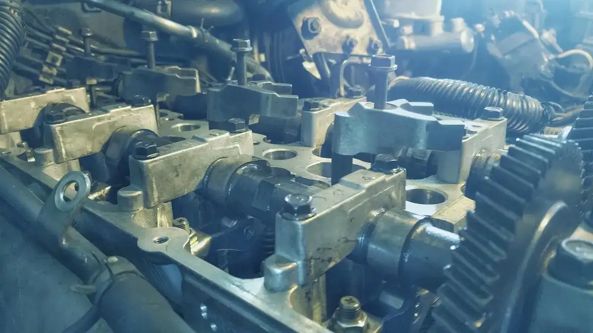 Close-up of an engine cylinder head with camshafts and valve springs exposed