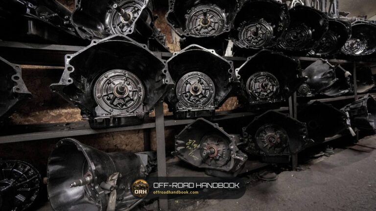 Rows of used automatic transmissions stacked on shelves in a repair shop