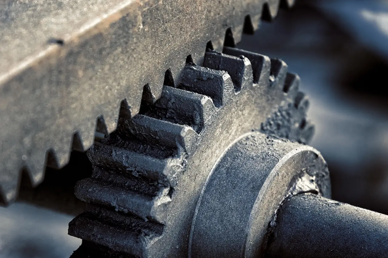 Close-up of a large metal gear with a toothed rack, showing gear teeth meshing; a generic gear photo, not a vehicle differential