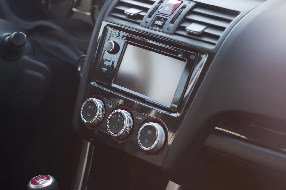 Dashboard of a car with a touchscreen radio, a power knob and climate knobs; the car is not a Jeep Compass