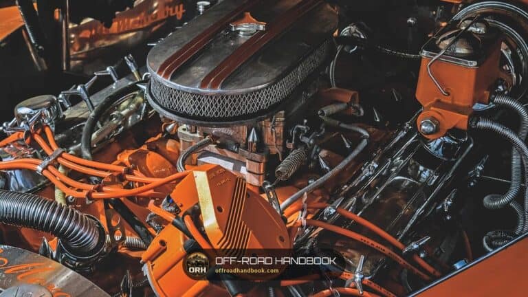 Engine bay of a V8 car with the Off-Road Handbook logo