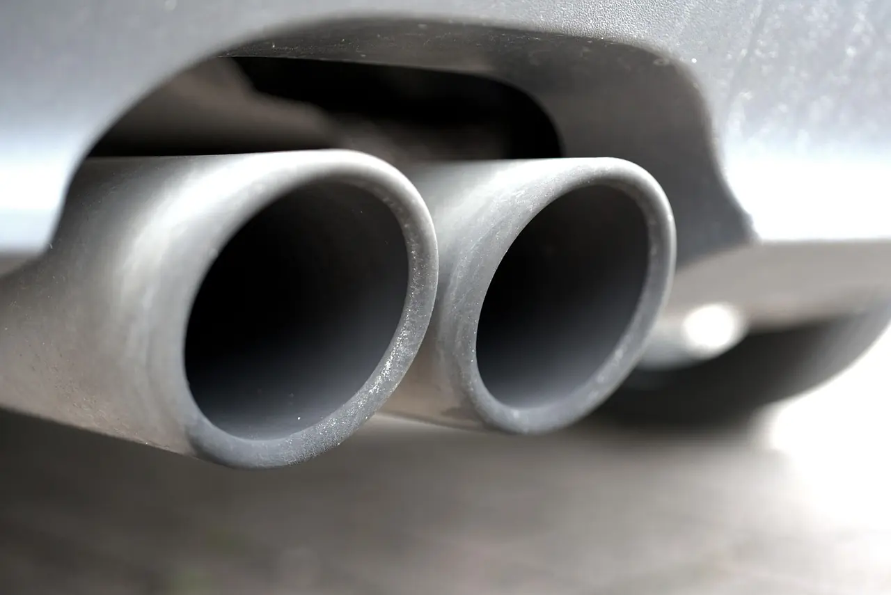 Twin exhaust tailpipes on a diesel car, shown to illustrate checking exhaust smoke color; not a Jeep