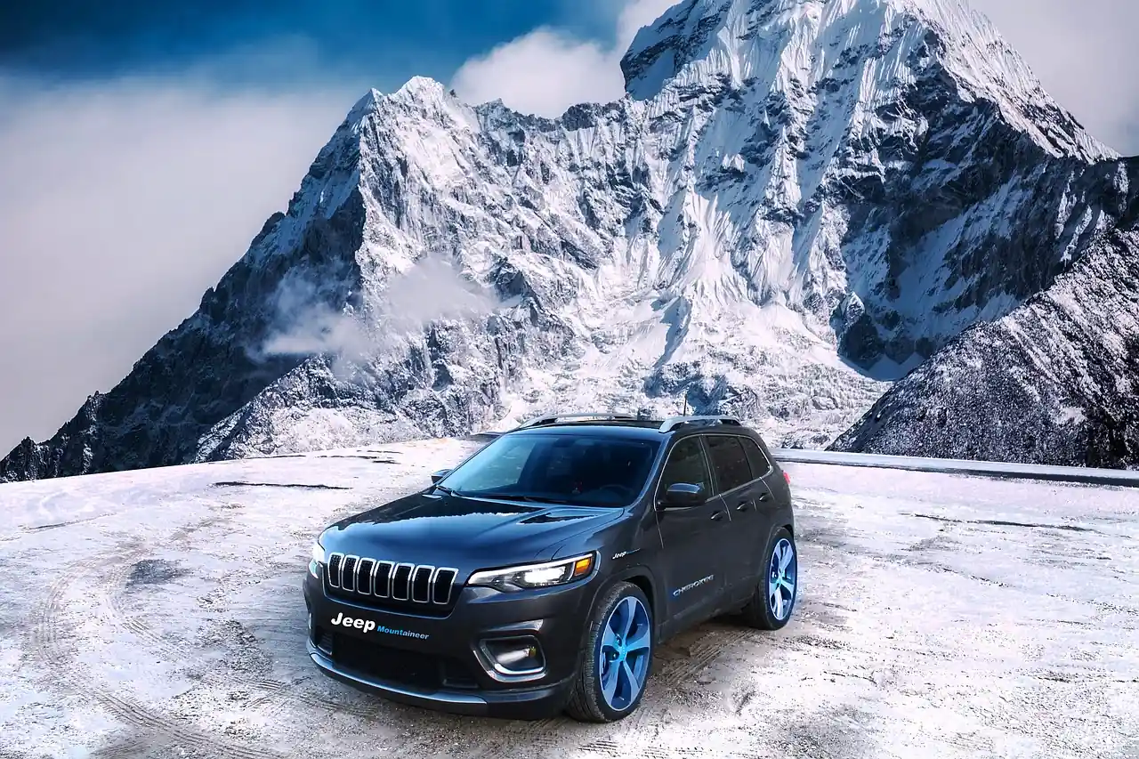 Gray Jeep SUV with the Jeep name on the front parked on snow with a snow-covered mountain behind