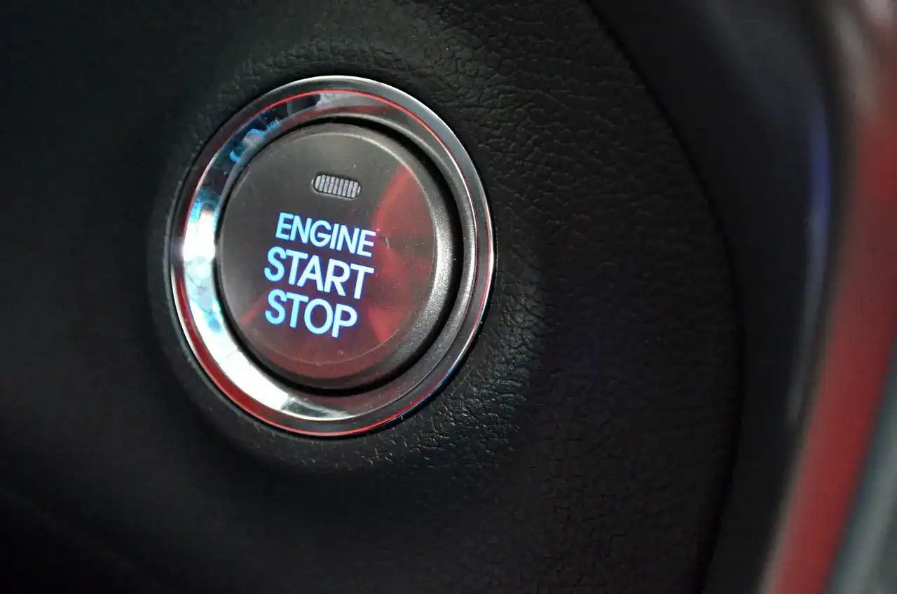 Illuminated engine start stop push button on a car dashboard