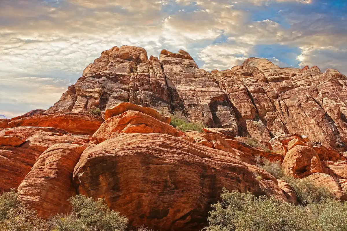 Red sandstone rock formations under a cloudy sky in the Las Vegas area desert