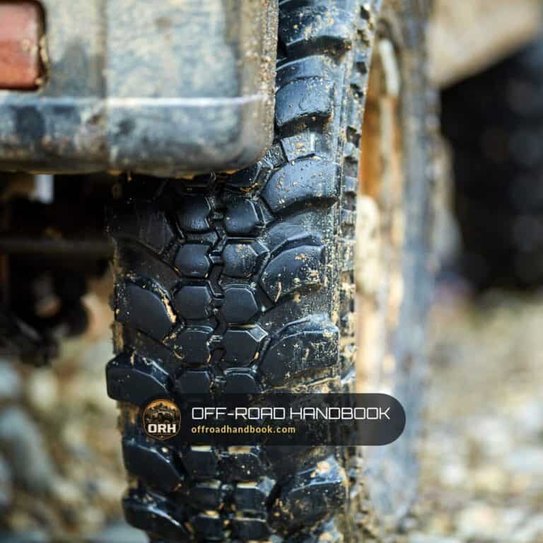 Close-up of a muddy mud-terrain off-road tire tread — Off-Road Handbook