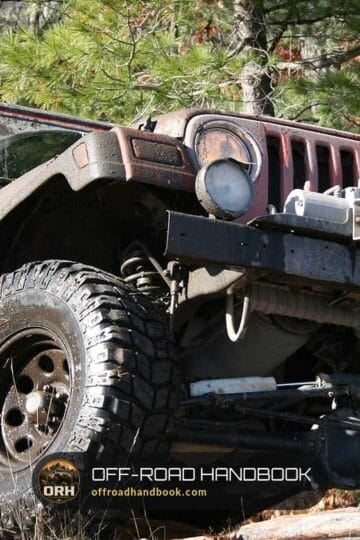 Weathered Jeep Wrangler with a winch on a rocky forest trail — Off-Road Handbook