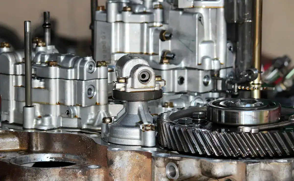 Close-up of an opened gearbox showing helical gears and bearings