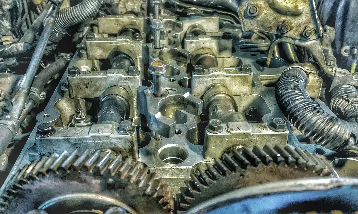 Top of an opened engine showing camshafts, cam gears and valve train parts