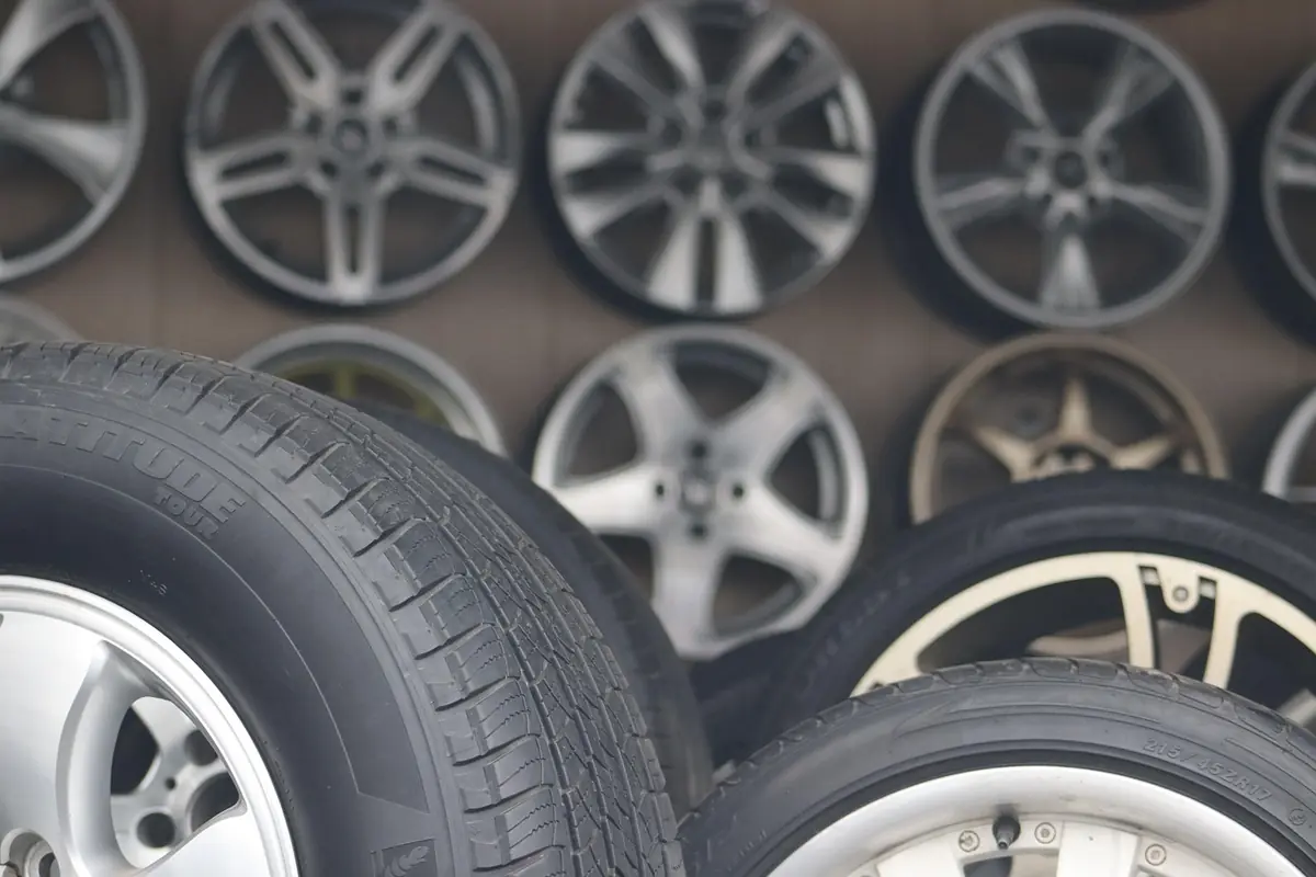 Stacked tires and alloy wheels on display in a tire shop