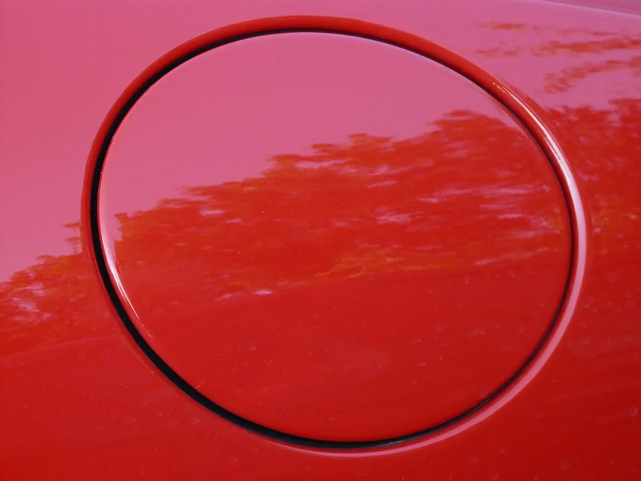 Closed fuel filler cap flush with a red car body panel, stock photo of a fuel cap and not an 800SX