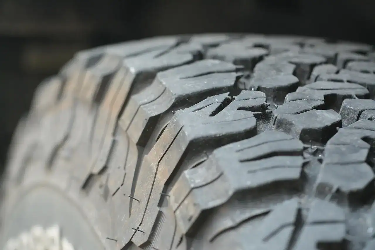 Close-up of the aggressive tread blocks on an all-terrain truck tire
