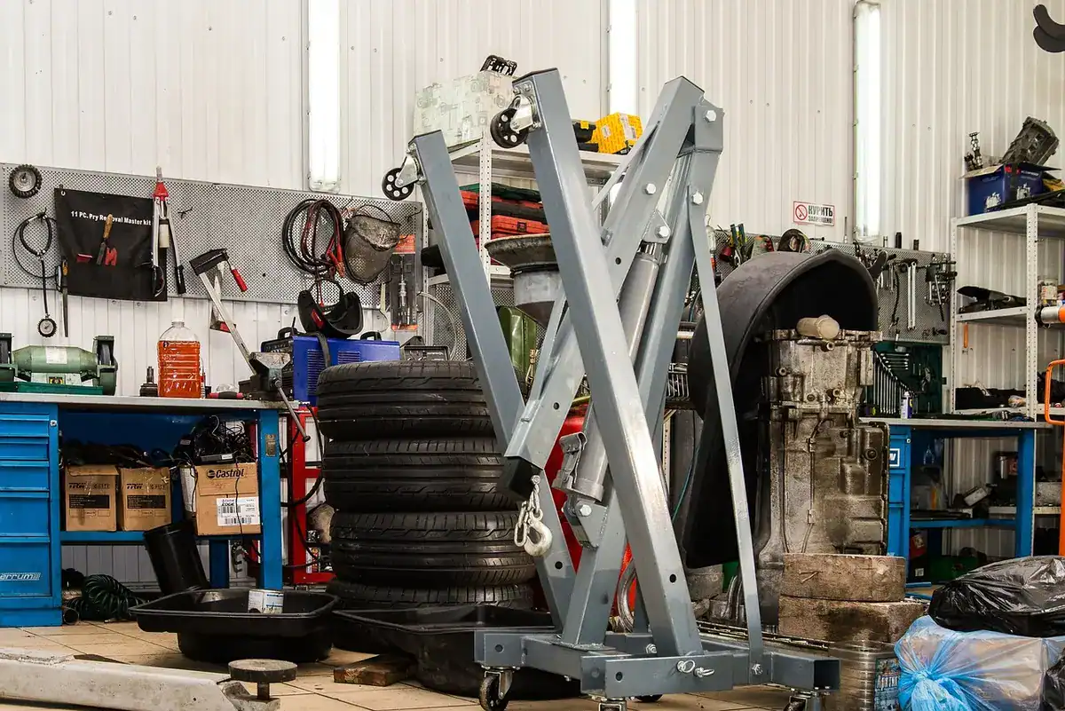 Repair shop with an engine hoist, tire stack and tool wall